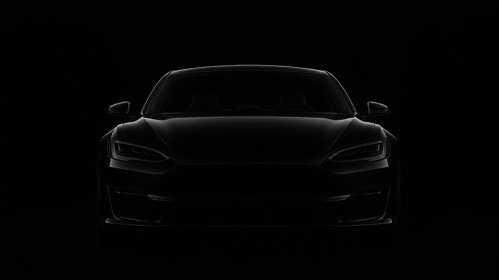 A dark vehicle emerging from shadow